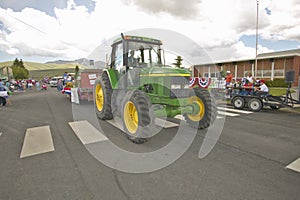 Tractor leading the Fourth of July parade down main street, in Lima Montana