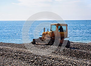 Tractor leveled gravel beach before swimming season