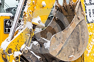 Tractor loader cleans snow after a snowfall