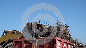 Tractor loader household waste at landfill.