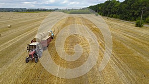 Tractor Loading Feed Straw Bales