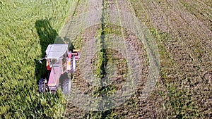 tractor with machinery for cutting and mowing grass in action