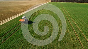 Tractor makes fertilizer on the field. Aerial survey