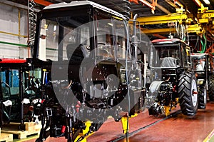 Tractor Manufacture work. Assembly line inside the agricultural machinery factory.