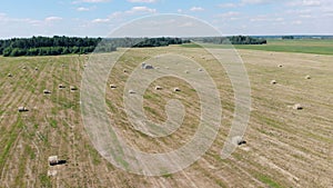 A tractor moves hayricks, top view.