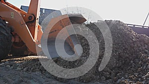 tractor moving and unloading gravel on old road reconstruction site