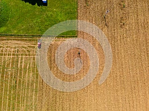 Tractor mowing agricultural  field. Aerial view.  Cultivating field.
