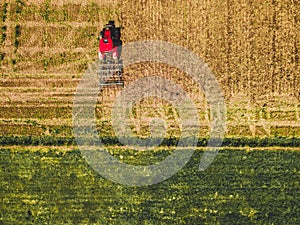 Tractor mowing agricultural  field. Aerial view.  Cultivating field.