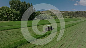 A tractor mowing a field of grass on a farm in South Africa 3