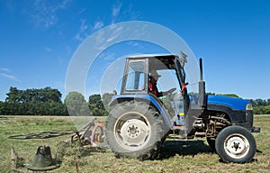 Tractor mowing green field