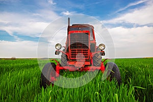 Tractor mowing green field