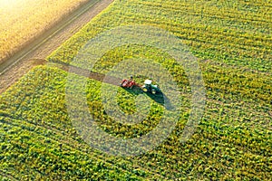 Tractor mowing green field, aerial view. Agriculture