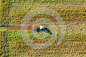 Tractor mowing green field, aerial view. Agriculture