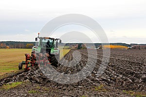Tractor and plough on a Field in Autumn photo