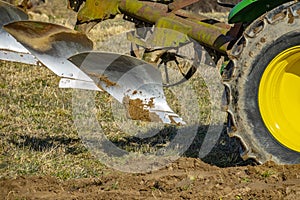 Tractor with plough plow close up