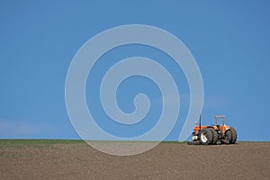 Tractor on ploughed field