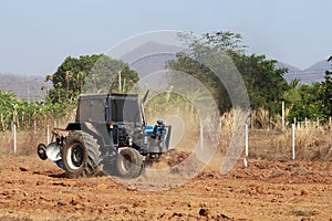 Tractor with Plougher and Grader Working photo