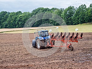 Tractor ploughs the field around