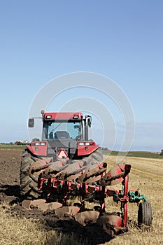 Tractor and plow at harvest