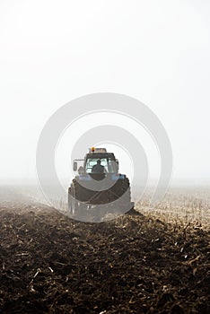 Tractor plowing field