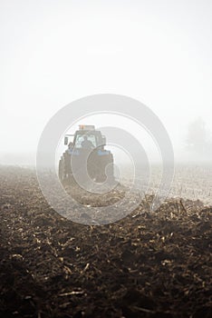 Tractor plowing field