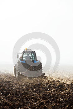 Tractor plowing field