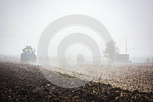 Tractor plowing field