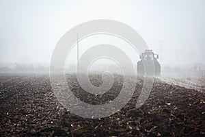 Tractor plowing field