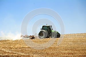 Tractor plowing field