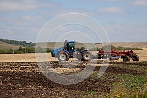 The tractor plowing a field.