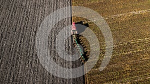Tractor plowing the field. Aerial shooting. Plowing fields