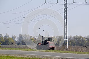 Tractor plowing a field and crows flying around him in search of food