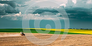 Tractor Plowing Field In Spring Season. Beginning Of Agricultural Spring Season