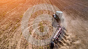 tractor plowing field top view, aerial photography with drone.