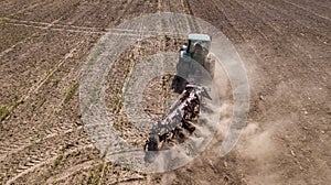 tractor plowing field top view, aerial photography with drone.