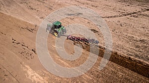 tractor plowing field top view, aerial photography with drone.