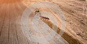 tractor plowing field top view, aerial photography with drone.