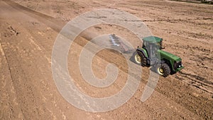 tractor plowing field top view, aerial photography with drone.