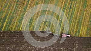 Tractor plowing field, view from above