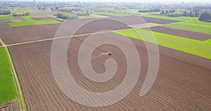 Tractor plowing the fields, aerial view of a plowed field and a tractor that sowing. Agriculture and Farming, campaign.