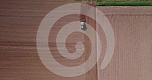 Tractor plowing the fields, aerial view of a plowed field and a tractor that sowing. Agriculture and Farming, campaign.