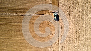 Tractor plowing the fields, aerial view, plowing, sowing, harvest. Agriculture and Farming, campaign