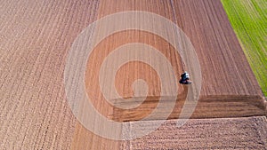 Tractor plowing the fields, aerial view, plowing, sowing, harvest. Agriculture and Farming, campaign