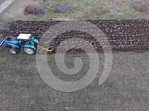 Tractor plowing the garden. Plowing the soil in the garden
