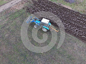 Tractor plowing the garden. Plowing the soil in the garden