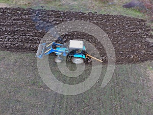 Tractor plowing the garden. Plowing the soil in the garden