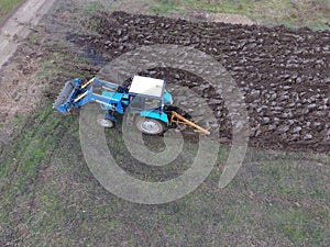 Tractor plowing the garden. Plowing the soil in the garden