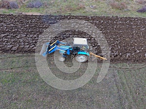 Tractor plowing the garden. Plowing the soil in the garden