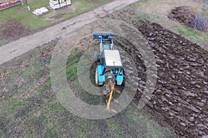 Tractor plowing the garden. Plowing the soil in the