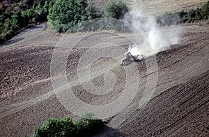 Tractor plowing a sloping field